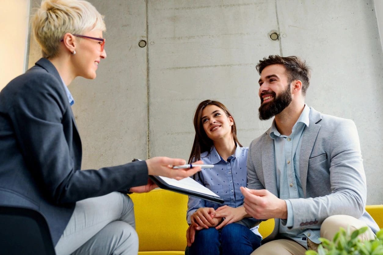 A woman and two men are talking to each other.